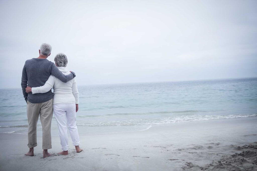 couple walking on beach in fog 1 1.jpg