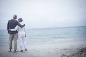 couple walking on beach in fog 1 1.jpg